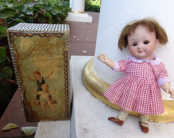 Antique collector's item antique doll with googly doll with closed mouth