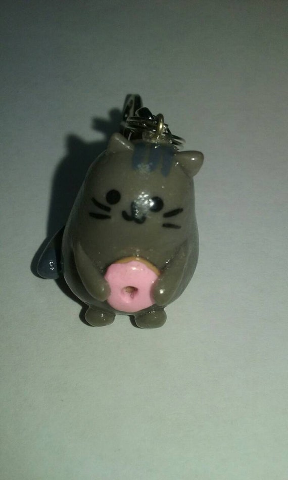 pusheen holding a donut