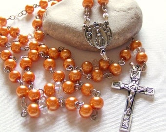 Handmade Catholic rosary with orange glass pearls in silver