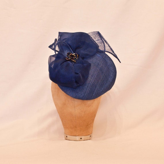 Handmade french blue occasion hat decorated with an asymmetric bow and jewel detailing