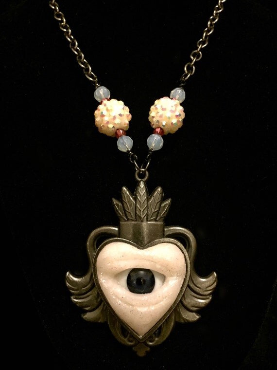 Items similar to Glittery Lover's Eye Necklace on Etsy