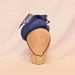 Handmade french blue occasion hat decorated with an asymmetric bow and jewel detailing