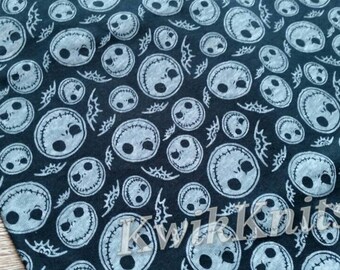Halloween fabric - white jack skeleton on black cotton jersey fabric. Great knit fabric for apparel.