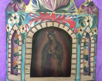 Virgin of Guadalupe behind glass with hand painted tin