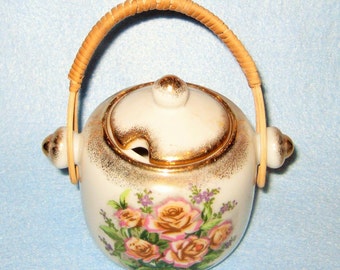 Vintage Sugar Bowl with Rattan Handle with glided floral design.