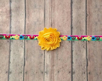 Sesame street character elastic headband featuring Elmo, cookie monster, big bird and Oscar for baby, toddler and adult