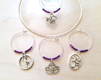 Yoga Wine Charms: Yoga Themed Wine Charms. Perfect gift for the Yogi in your life. Includes Om, Lotus Flower, Namaste, Tree Pose. Set of 4.