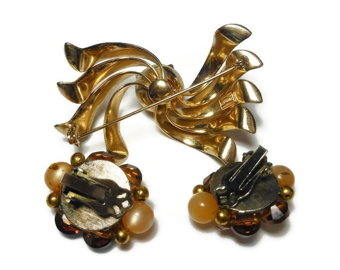 Marvella 1950s brooch and earrings set, a gold ribbons with gold splattered glass bead center, clip earrings have aurora borealis beads AB