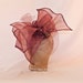 Handmade dusky plum asymmetric bow ladies hat decorated with veil and bead detailing