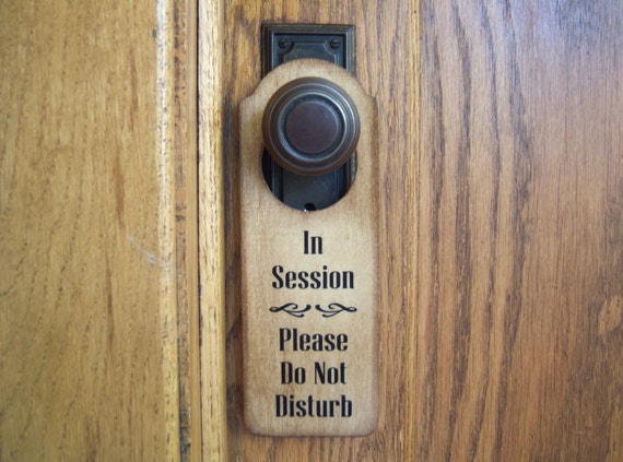 Please Do Not Disturb and In Session Messages on Wooden Door