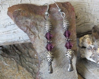 Metallic and purple dangle earrings.