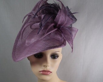 A hatinator/fascinator in dusky pinky/plum shades