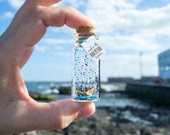 and so the adventure begins. Origami. Paper boat. Ship into a bottle. paper ship. Bottle ship. Message in a bottle. Special home card.