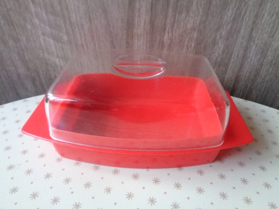 Vintage red plastic butter dish with clear plastic lid.