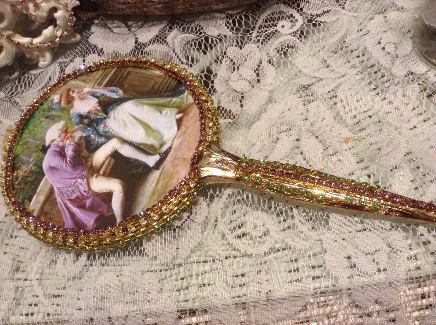 Jeweled hand mirror in purple green and clear jewels with