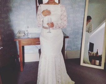 Bespoke ivory lace wedding dress with scalloped edges and pearls.