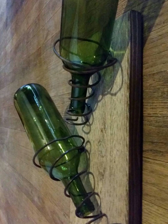 Wall mounted wine rack made with bed springs and found wood