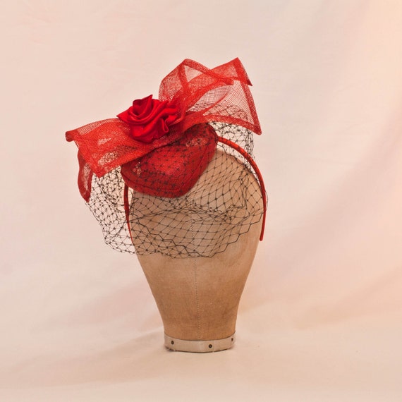Handmade red heart shaped ladies fascinator/hat decorated with bow and ribbon rose and black veil