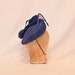 Handmade french blue occasion hat decorated with an asymmetric bow and jewel detailing
