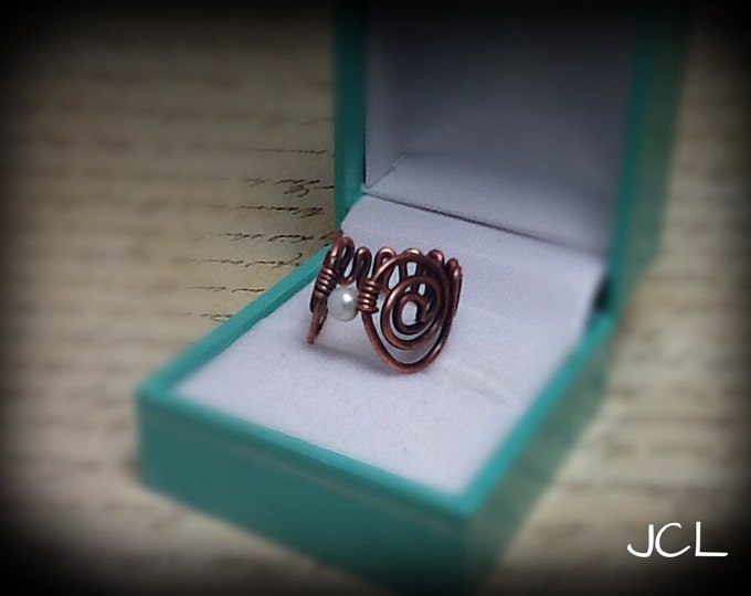 Wire wrapped copper ring with pearl and scroll band