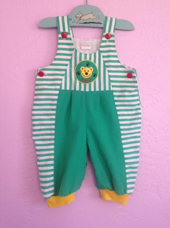 teddy bear with green overalls