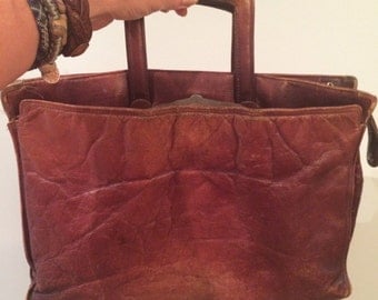 vintage, tattered, worn, scuffed old brown leather briefcase, total bohemian style bag, movie prop