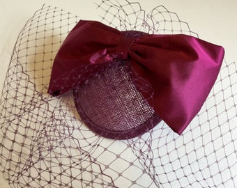 Magenta bow fascinator, plum cocktail hat, birdcage veil.