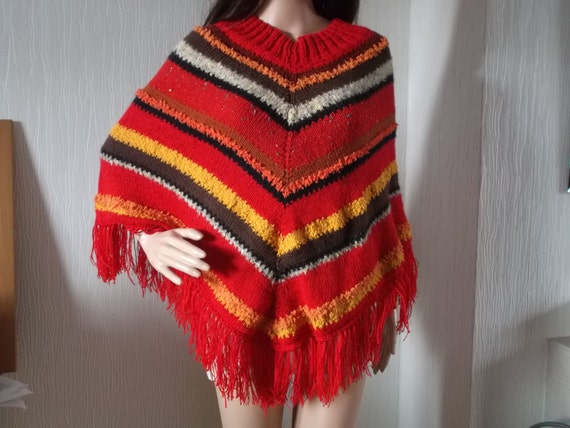 Retro style poncho in reds, brown, and orange colours of Autumn hand knitted from up-cycled yarn