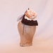 Coffee brown hat decorated with a peach rose and tulle