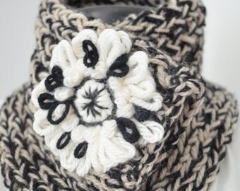 Neck warmer, scarf for winter in wool, black and white with pin-shaped flower