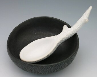 Carved white porcelain twig spoon and black bowl, salt holder, sugar bowl, food container