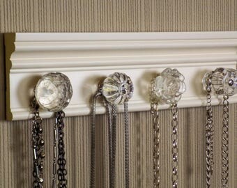 OFF White necklace rack. This jewelry organizer wall hanging features 4 clear glass or acrylic decorative knobs total /12 " jewelry storage