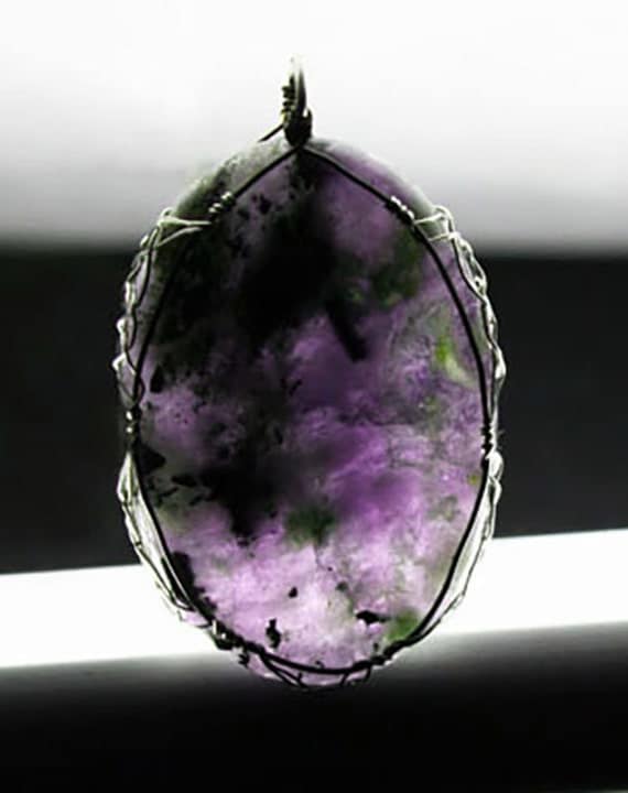 Iolite cabochon wrapped Celtic style with silver and copper