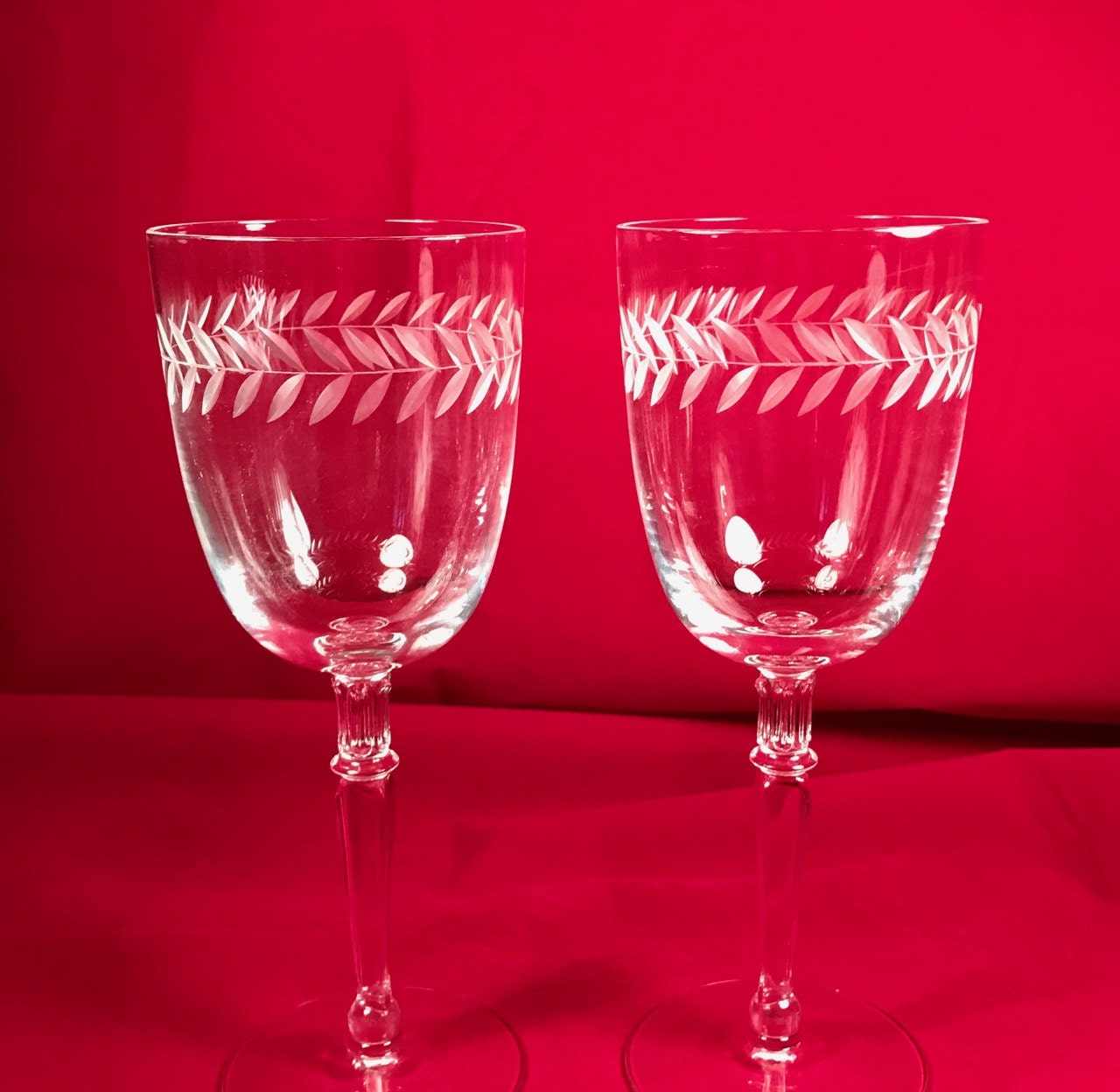 Two Vintage Wine glasses. Tall stemmed with etched laurel