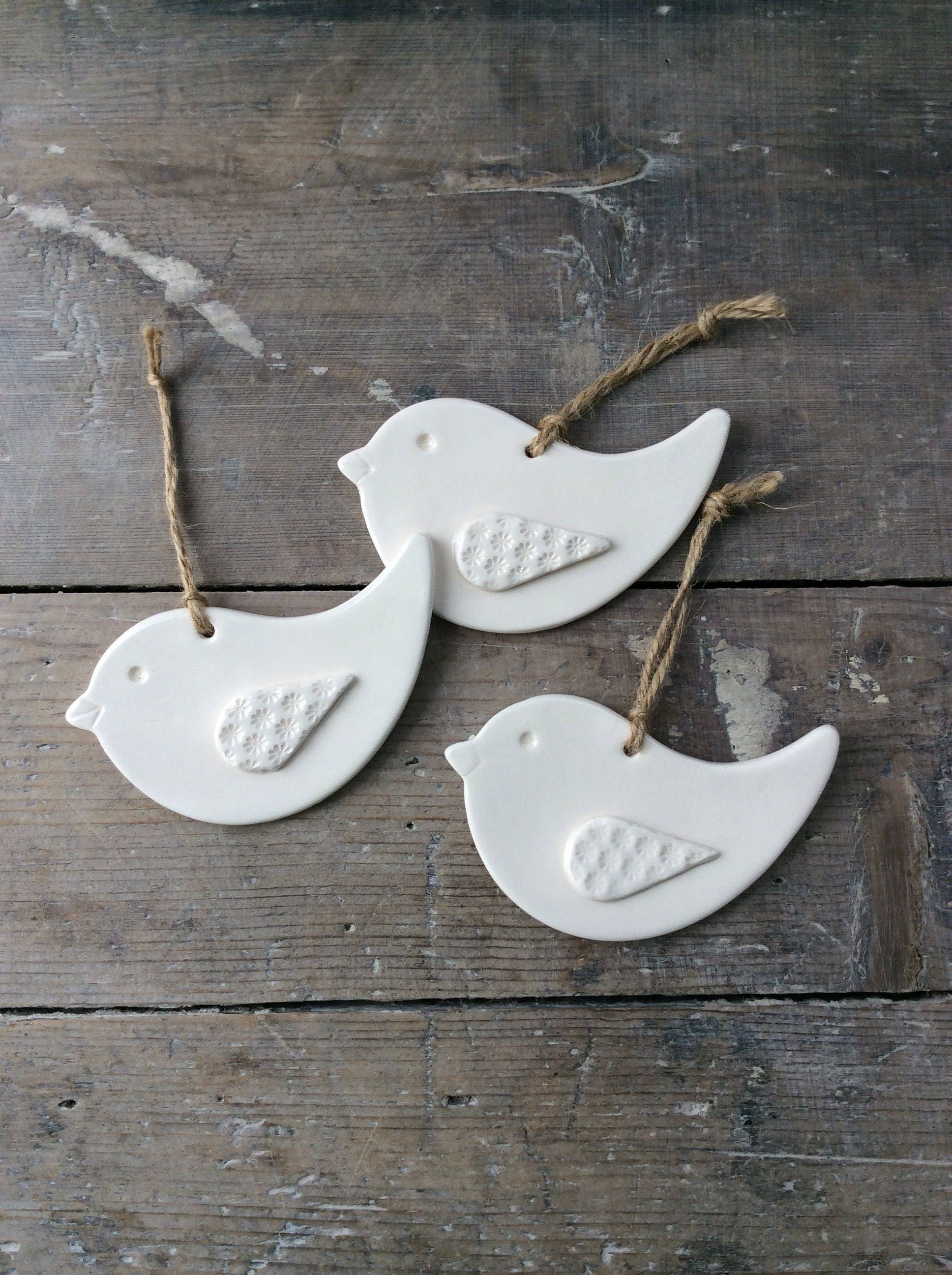 Handmade ceramic hanging white bird decorations. Home decor
