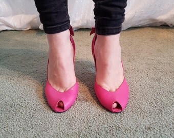 Pink Saxone stiletto heels with peep toe.