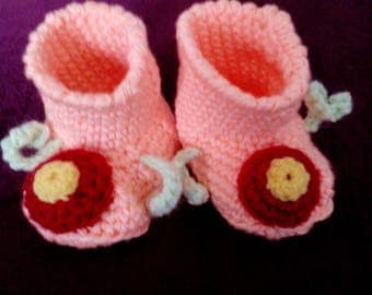 Self-crocheted baby booties in pink