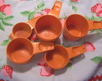 orange tupperware measuring cups