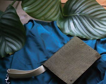 white, black and golden tobacco bag