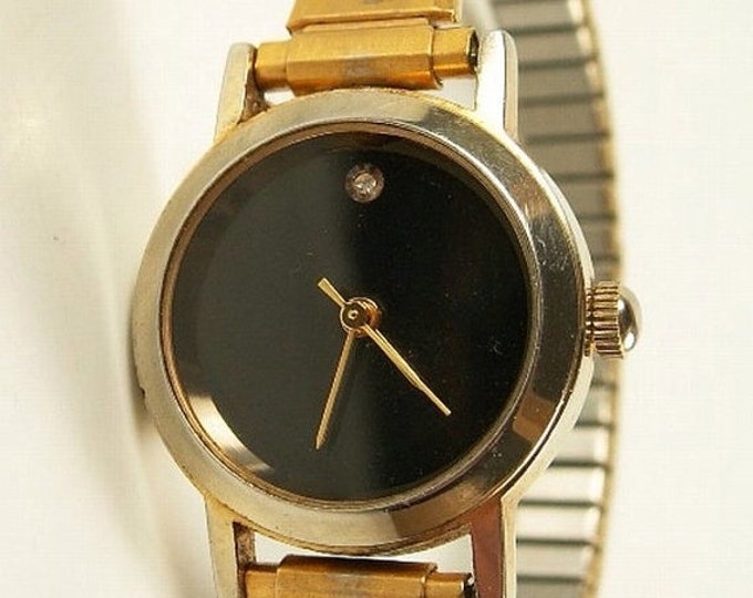 Storewide 25% Off SALE Lovely Vintage Ladies Designer Mechanical Gold Tone Black Dial Watch Featuring Twist-A-Flex Adjustable Band