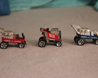 Hot Wheels, 2 Radio Flyers and one Grocery Cart