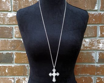 A large madonna style crystal cross necklace. 18 long. New