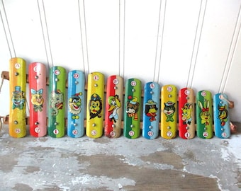 Vintage metal toy xylophone as is for wall hanging decor colorful animal graphics musical toy instrument