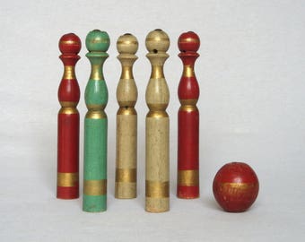 antique skittles game with wooden pins and iron bumbers