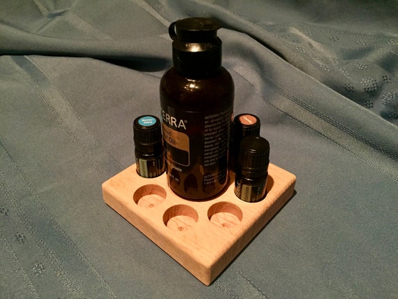 Massage Kit Oil Holder, White Oak Massage Kit Oil Holder, White Oak Massage Kit Oil Holder, White Oak ?zoom  Request a custom order and have something made just for you. Item details 5 out of 5 stars.      (1) reviews Shipping & Policies Do you have your favorite massage oils in 5ml bottles? This holder was designed specifically for dōTERRA's AromaTouch Technique Kit, including space for fractionated coconut oil. Keep your massage tools at the ready to offer the healing touch of massage and oils! Will hold any 5ml bottles or 4oz bottle in the center. This holder is made of white oak. Meet the owners of BalanceShared Learn more about their shop and process  Michelle Lasley    Peter Lasley Massage Kit Oil Holder, White Oak