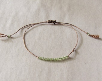 tiny PERIDOT beaded bracelet on a thin silk cord with tiny fine silver bead hand knotted gemstone layering August birthstone minimalist