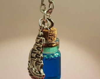Glass vials with ship charm on silver chain
