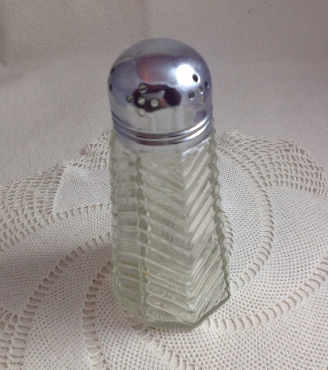 Vintage pressed glass sugar shaker with chrome top