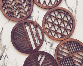 Laser cut laser engraved geometric wooden coasters in oak