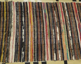 Handmade carpet. Hand weaving. Carpet, made of drape, cashmere, faux fur. Rug with stripes multicolor.